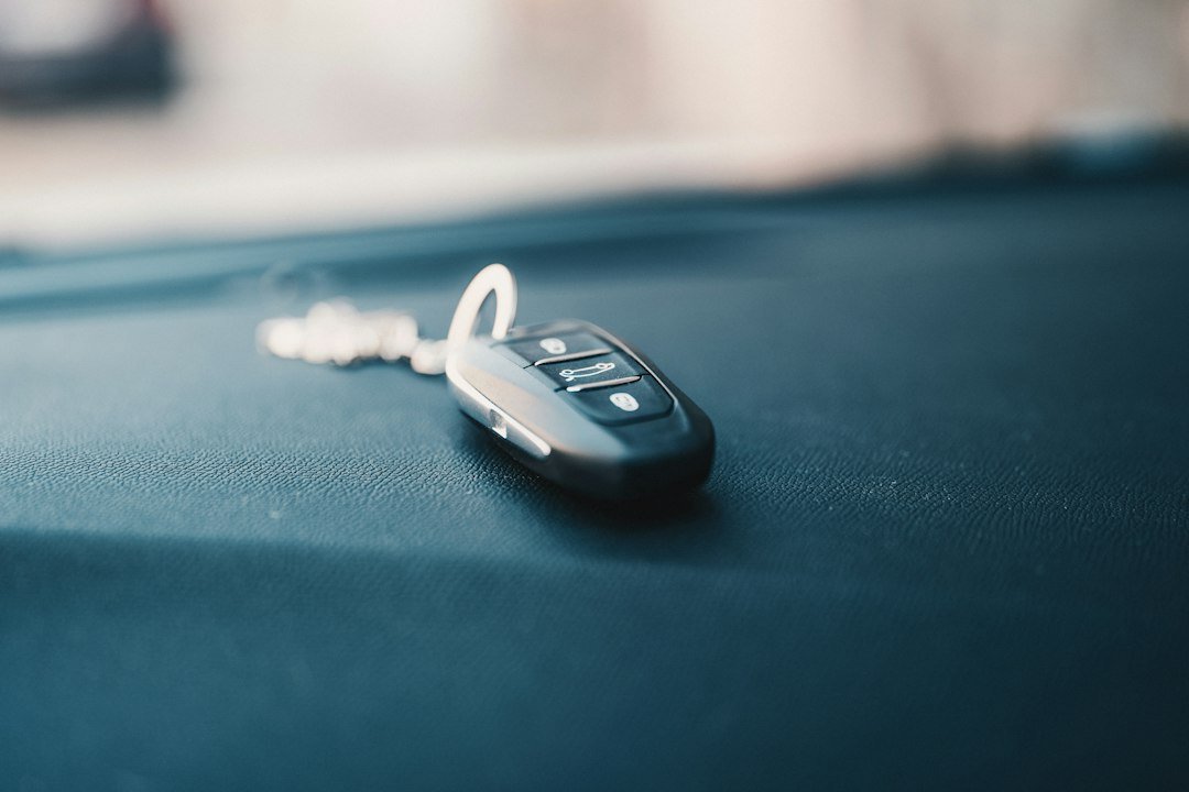 Black vehicle key fob with lock and unlock buttons