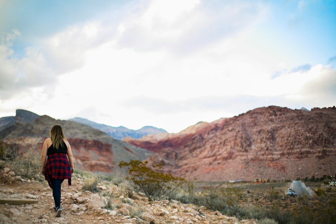 Hiker exploring Red Rock Canyon sandstone terrain near Las Vegas