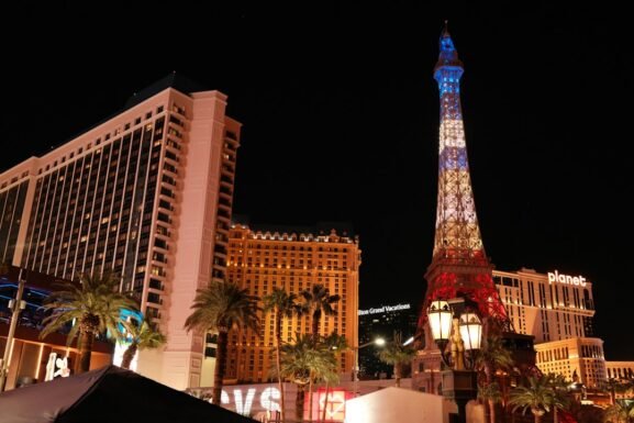 Las Vegas Strip resort hotel buildings and Eiffel Tower replica illuminated at night